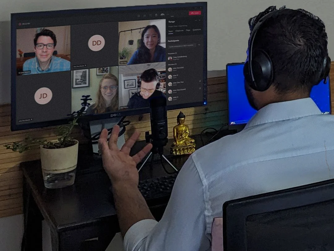 Nikhil Sharma on a client video call, several participants on camera and two with cameras off